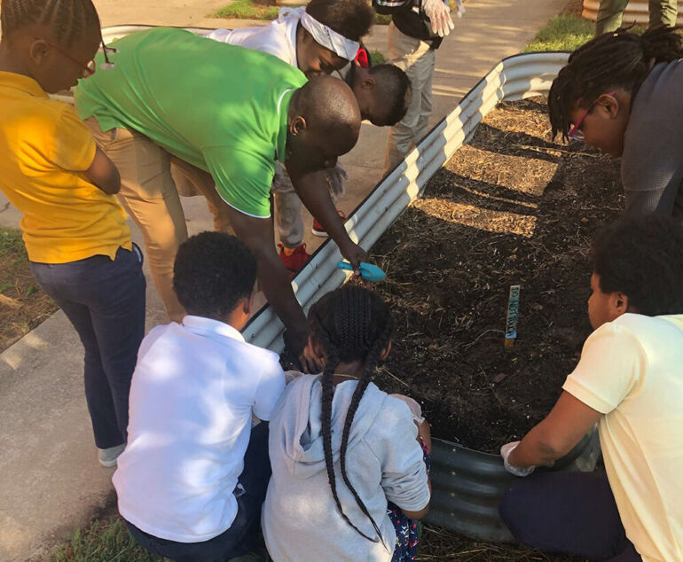 Students helping build a garden bed