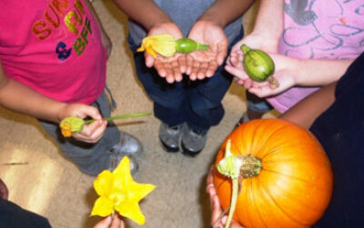 Students holding flowers and vegetables