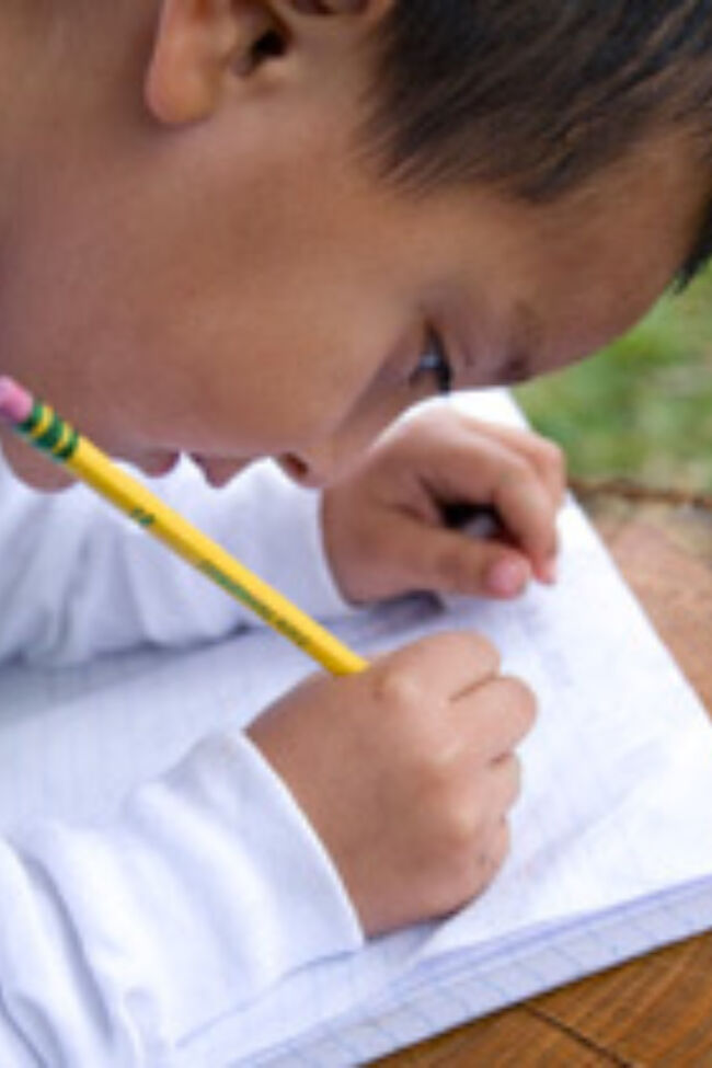 Student writing in notebook