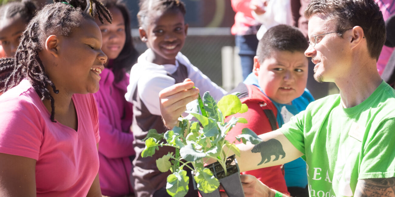 Teacher with students in veggie garden