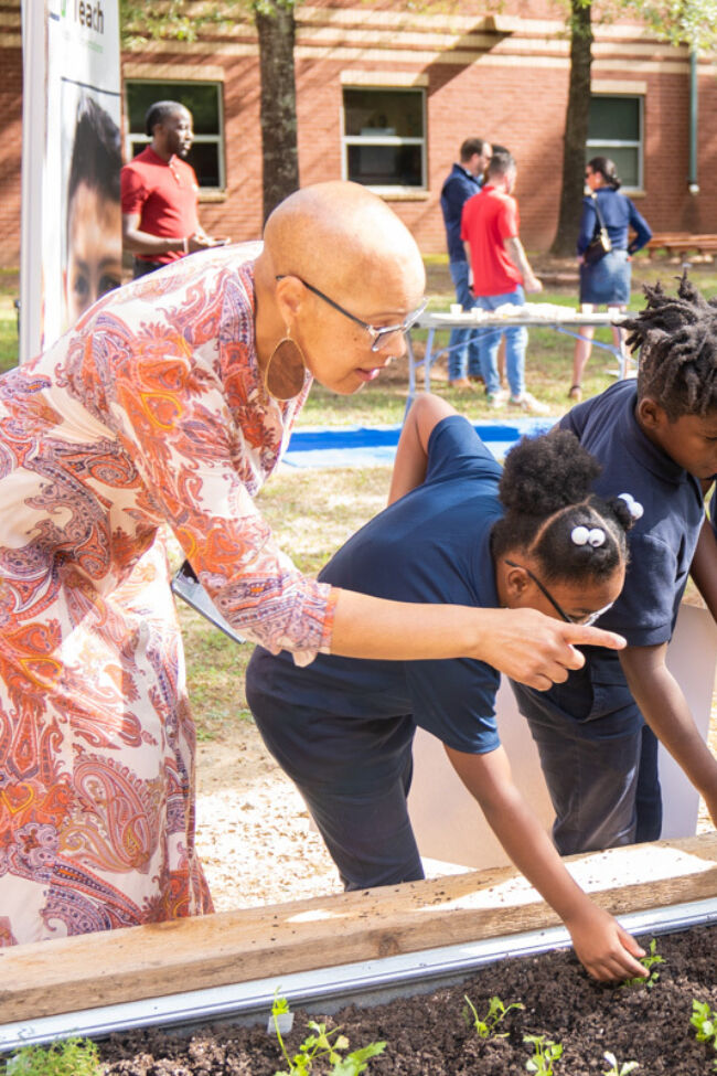 Students inspecting garden bed