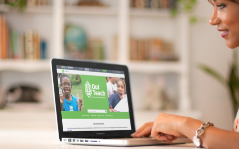 Mockup of a girl in a flower garment using a macbook at home