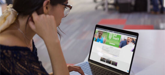 Woman looking at out teach website on computer