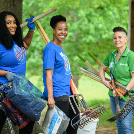 COX Event - Volunteers carrying shovels