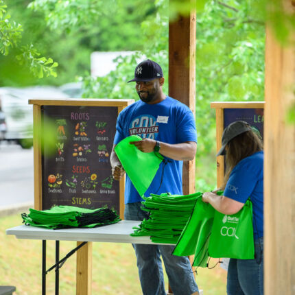 COX Event - Volunteers holding bags