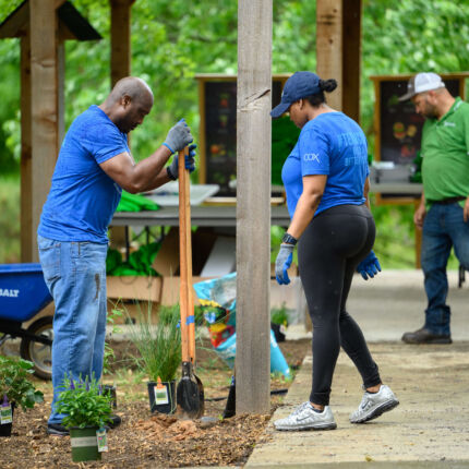 COX Event - Volunteers shoveling in garden