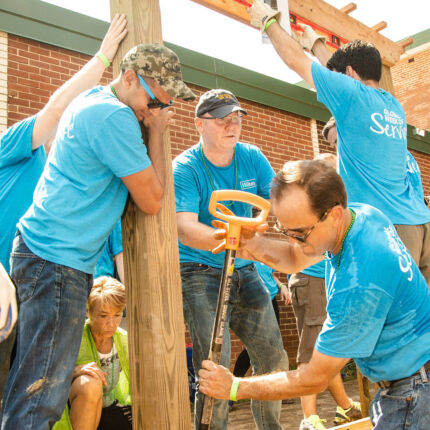 Hilton Event - Volunteers digging garden bed