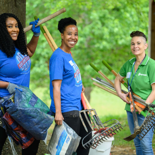 COX Event - Volunteers carrying shovels