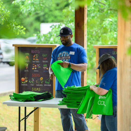 COX Event - Volunteers holding bags