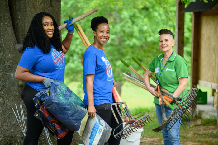 COX Event - Volunteers carrying shovels