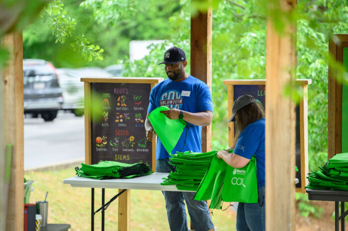 COX Event - Volunteers holding bags