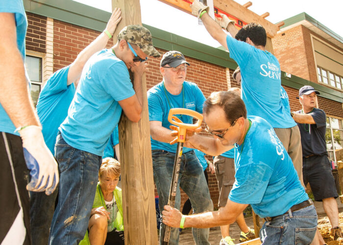 Hilton Event - Volunteers digging garden bed