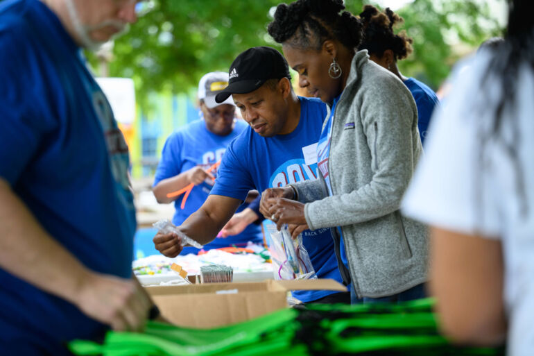 COX Event - Volunteers handing out supplies